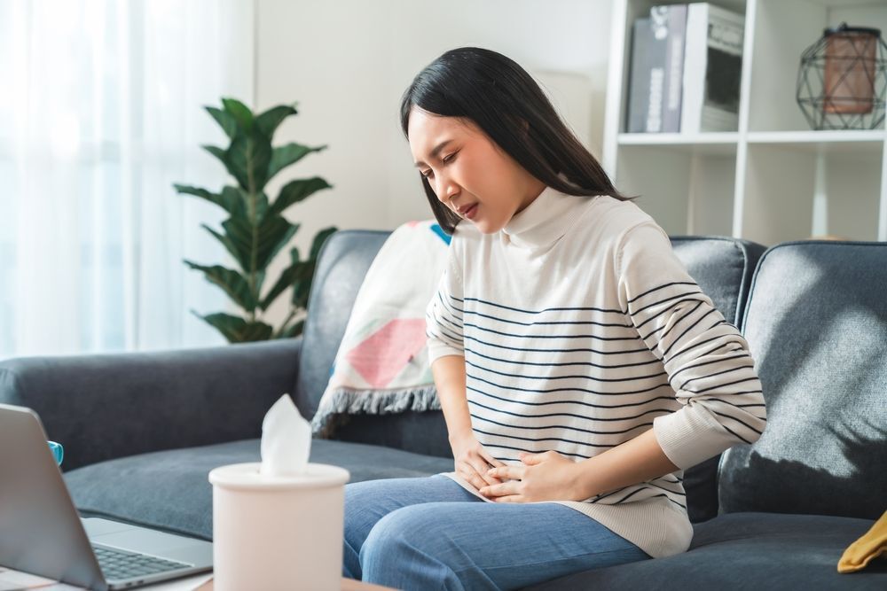 Woman touching her stomach in pain during her period.