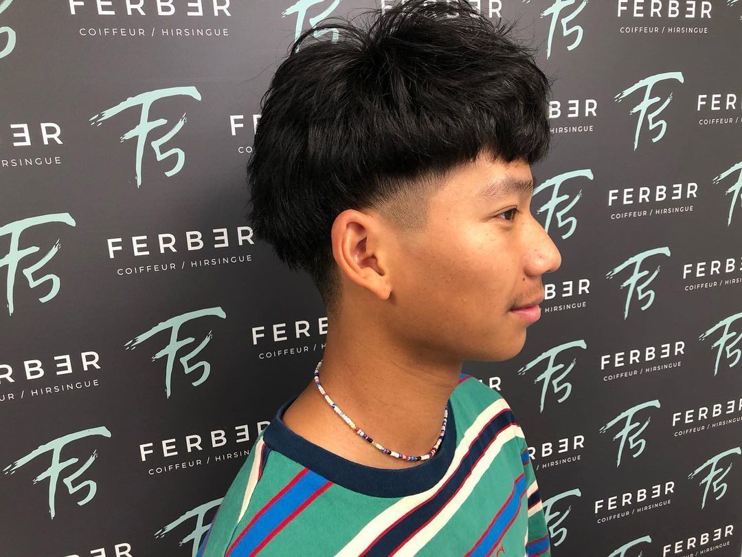 Man with long Edgar cut and faded sides.