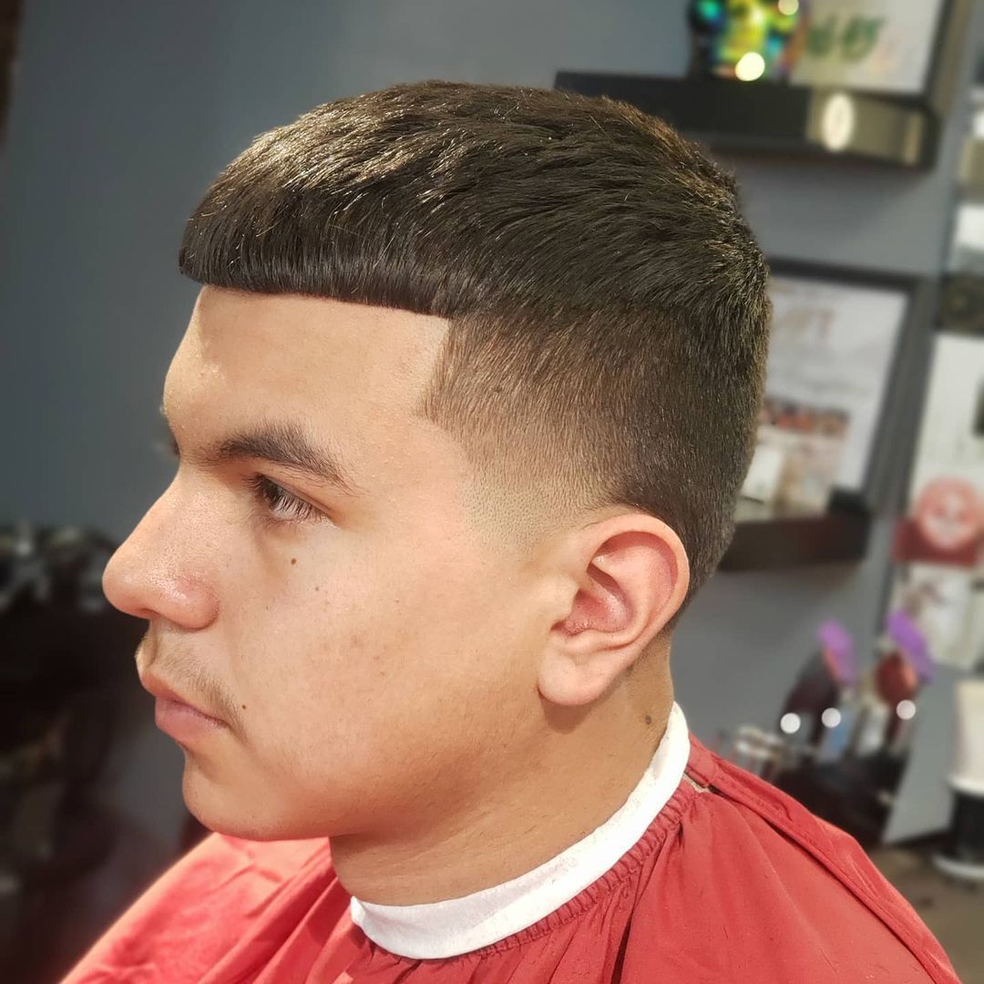 Man with short Edgar cut and tapered cut on the sides.