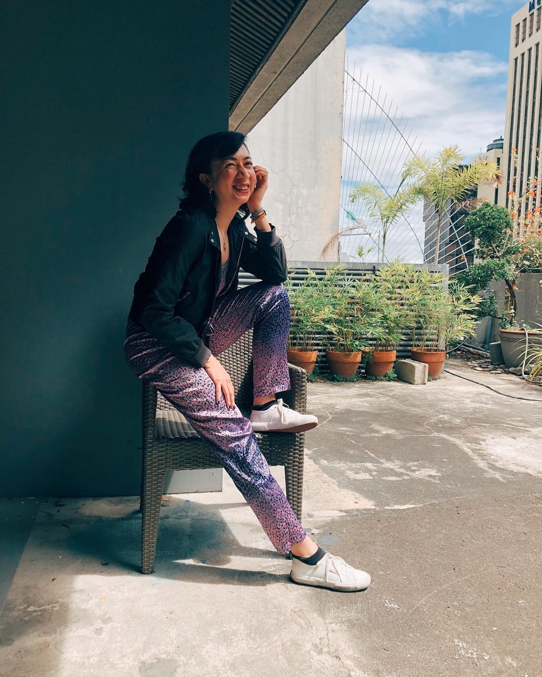 A smiling woman sitting on an armchair