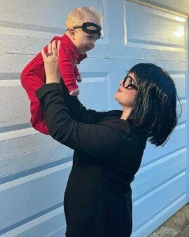 Woman and baby dressed up as Edna mode and Jack-Jack from The Incredibles.