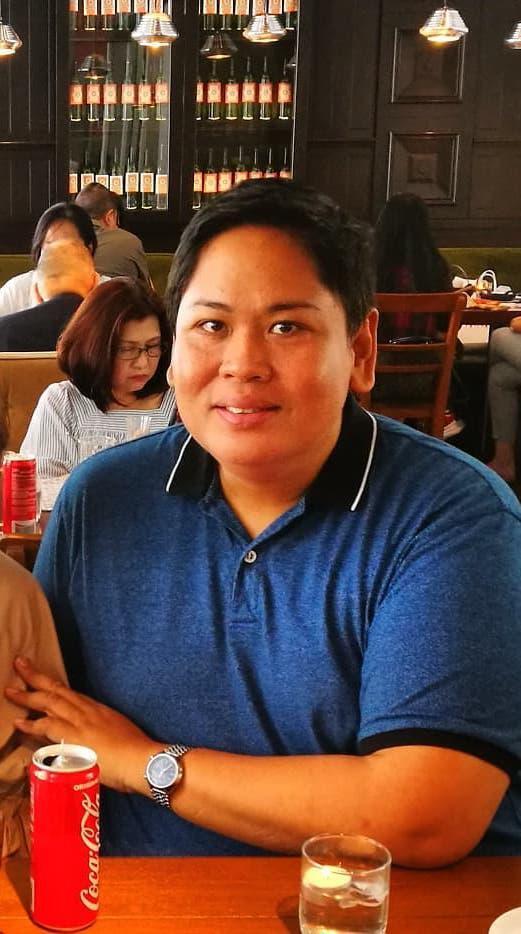 Close up of a man in a blue shirt