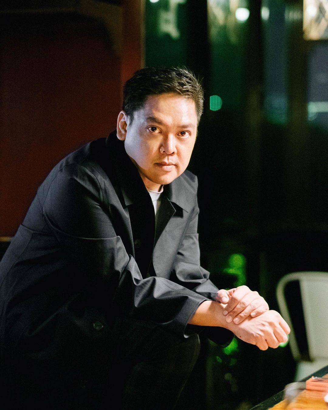 Man in a black jacket posing