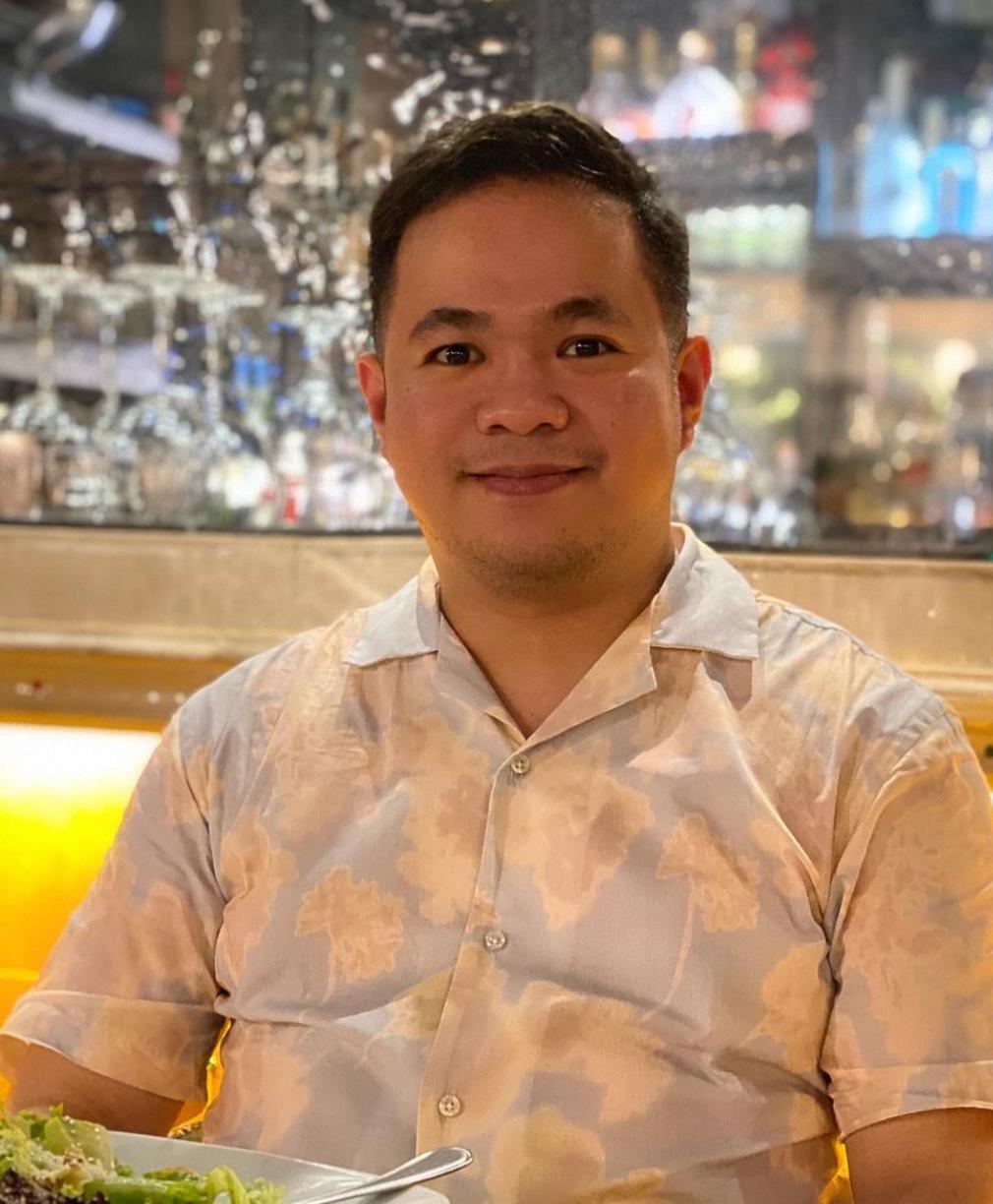 Man in a printed shirt smiling