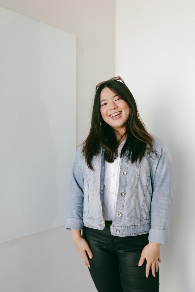 Woman in a denim shirt smiling
