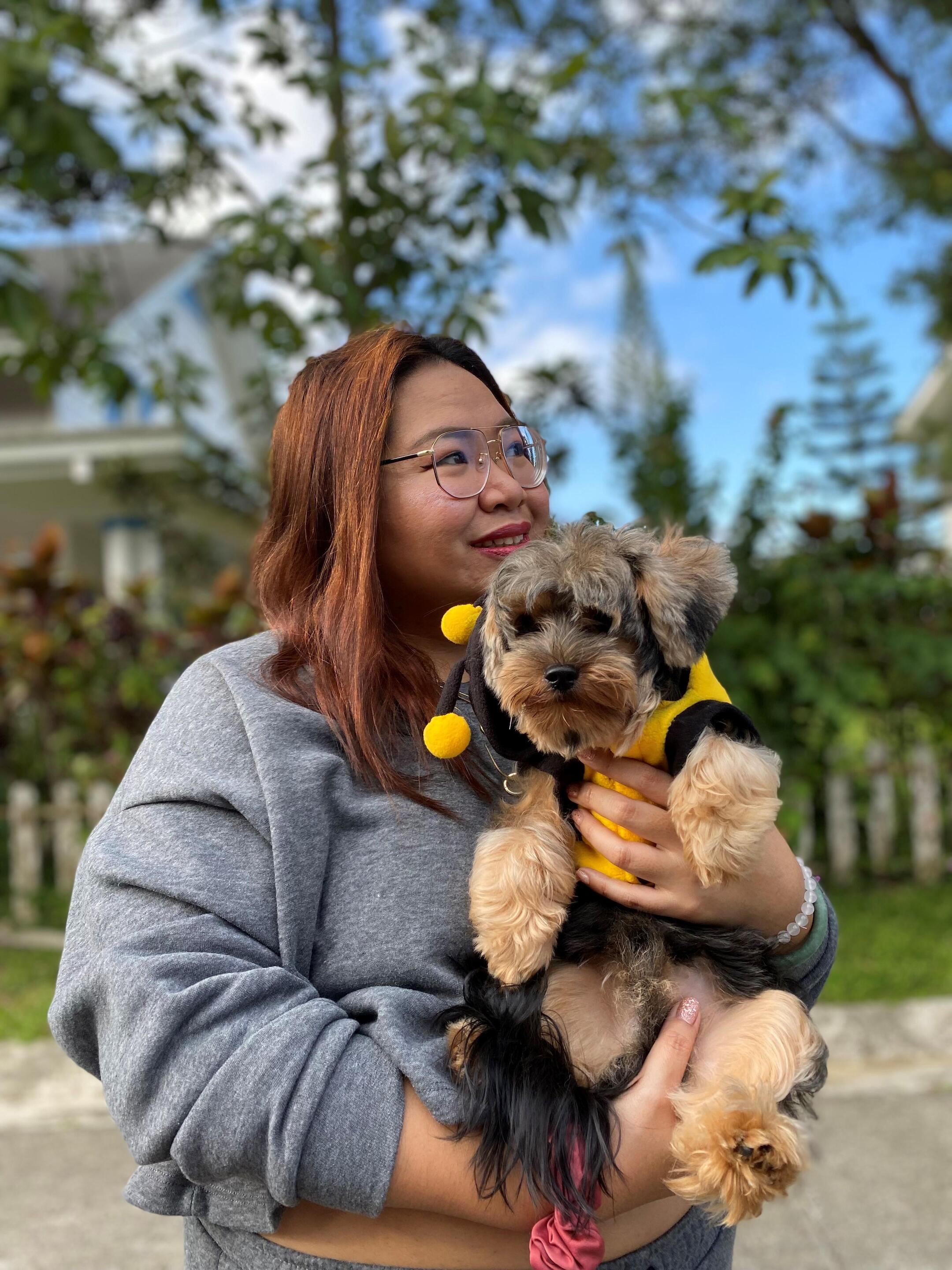 Woman with short black hair wearing a red leather jacket
