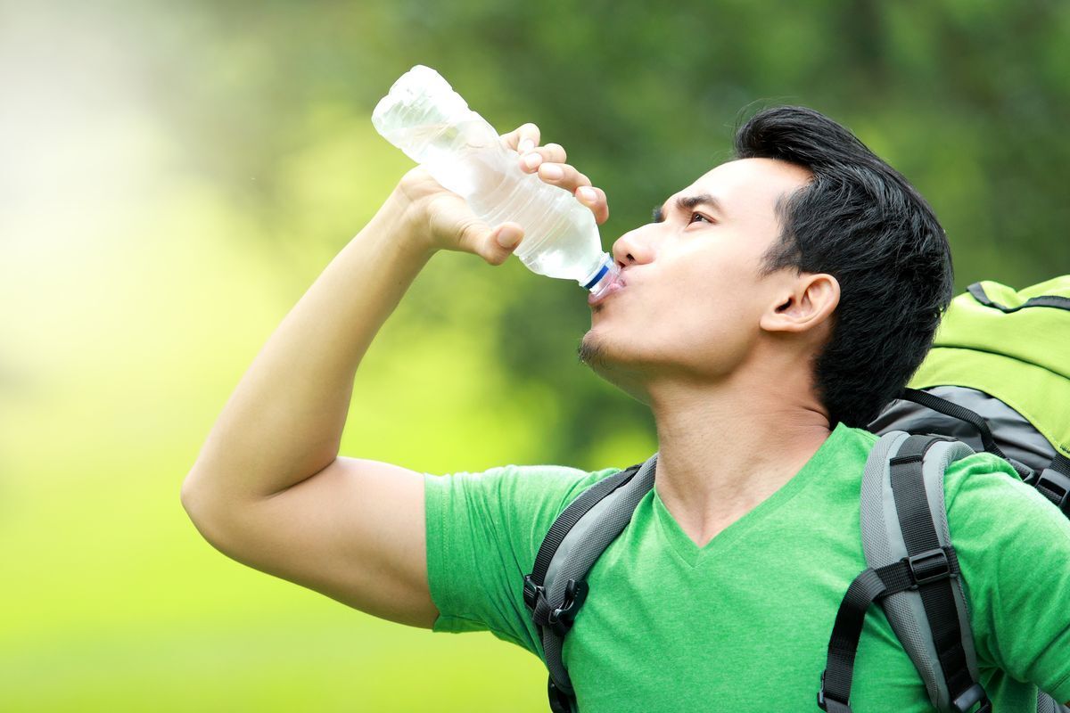 Asian man drinking water