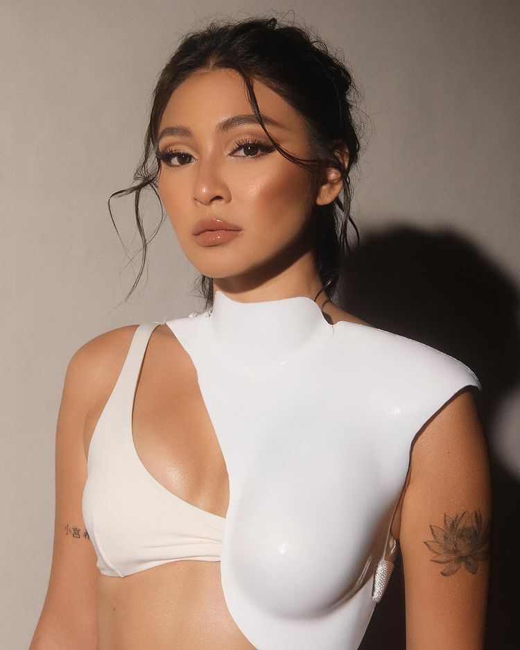 Asian woman in white top and tanned skin