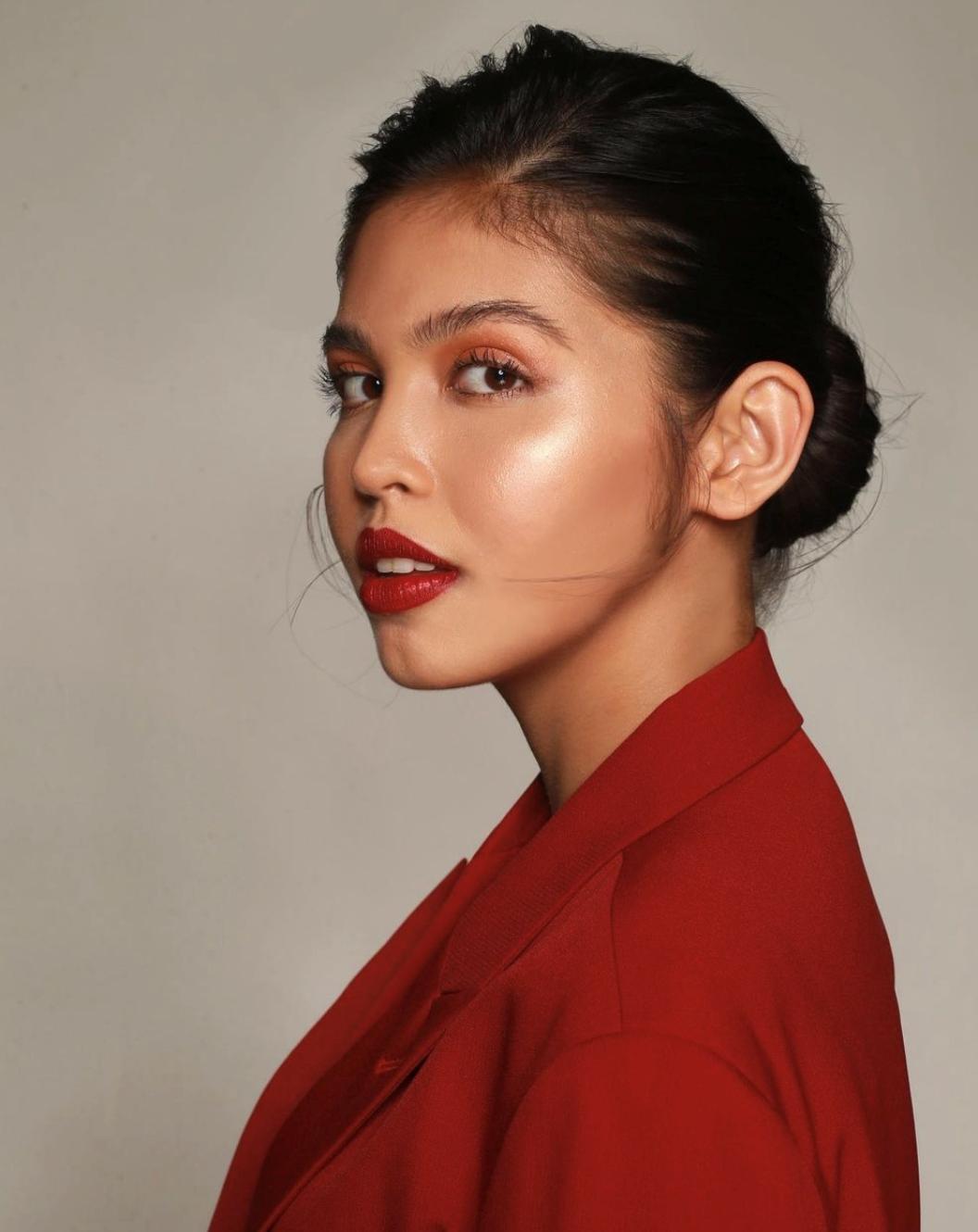 Filipino woman with red lipstick and red blazer