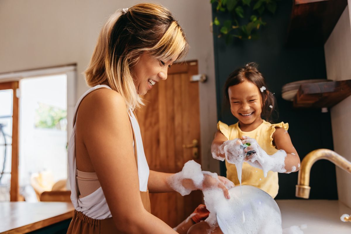 Mom and daughter washing the dishes