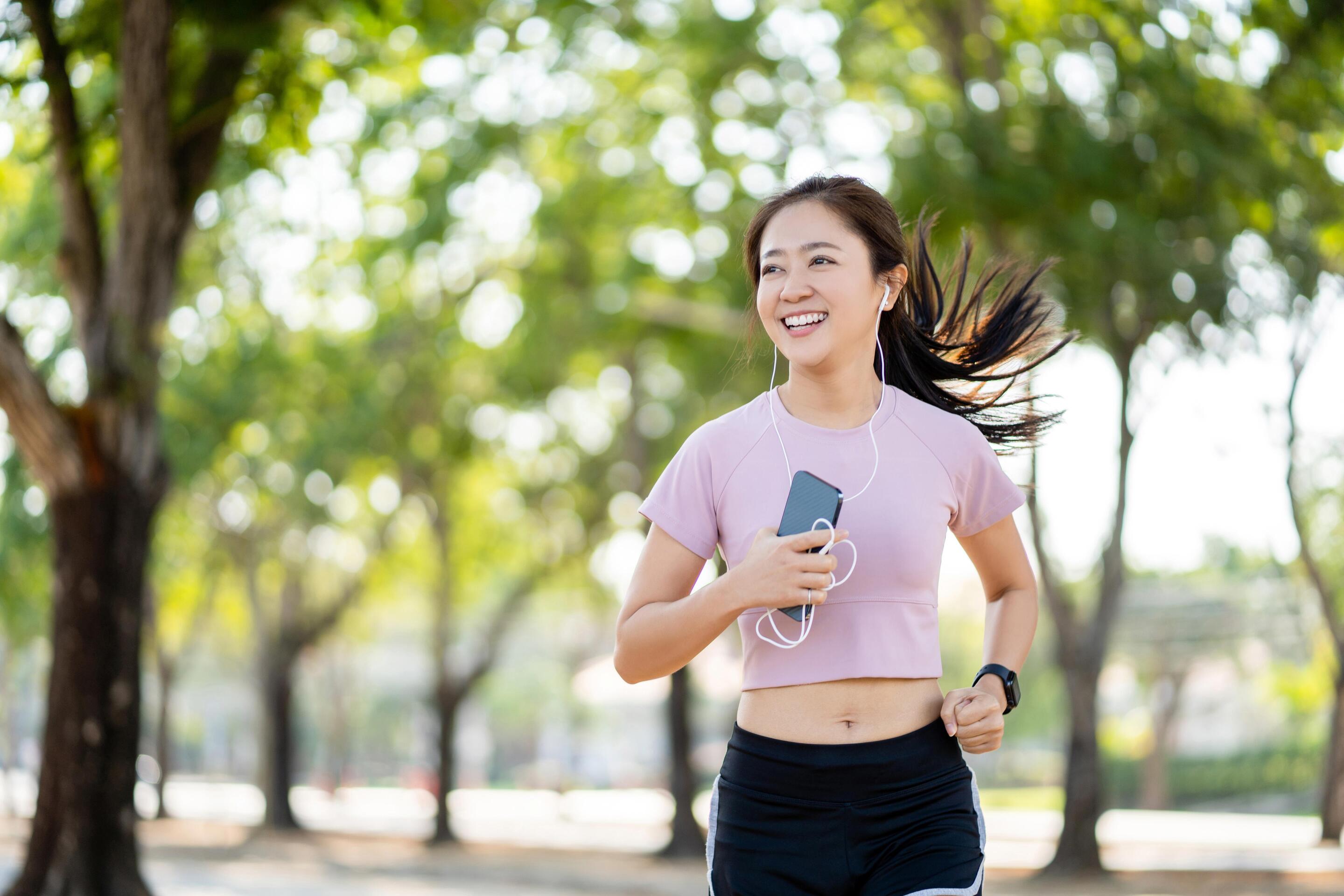 Healthy Asian woman running outdoors