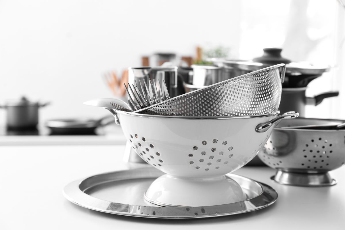 A stack of kitchen strainers on a countertop.