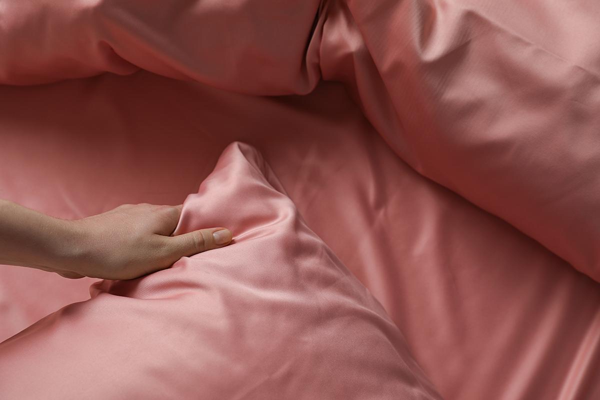 Woman touching silk pillowcases
