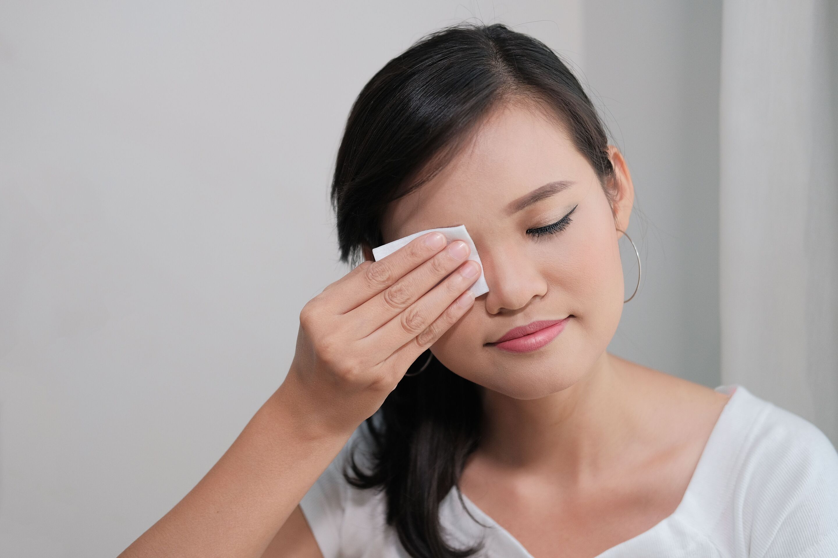 Asian girl removing her makeup.