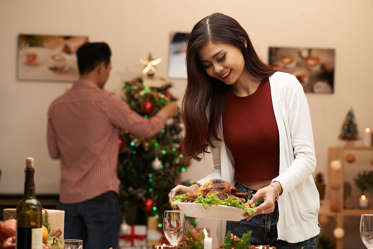 Asian woman setting the table