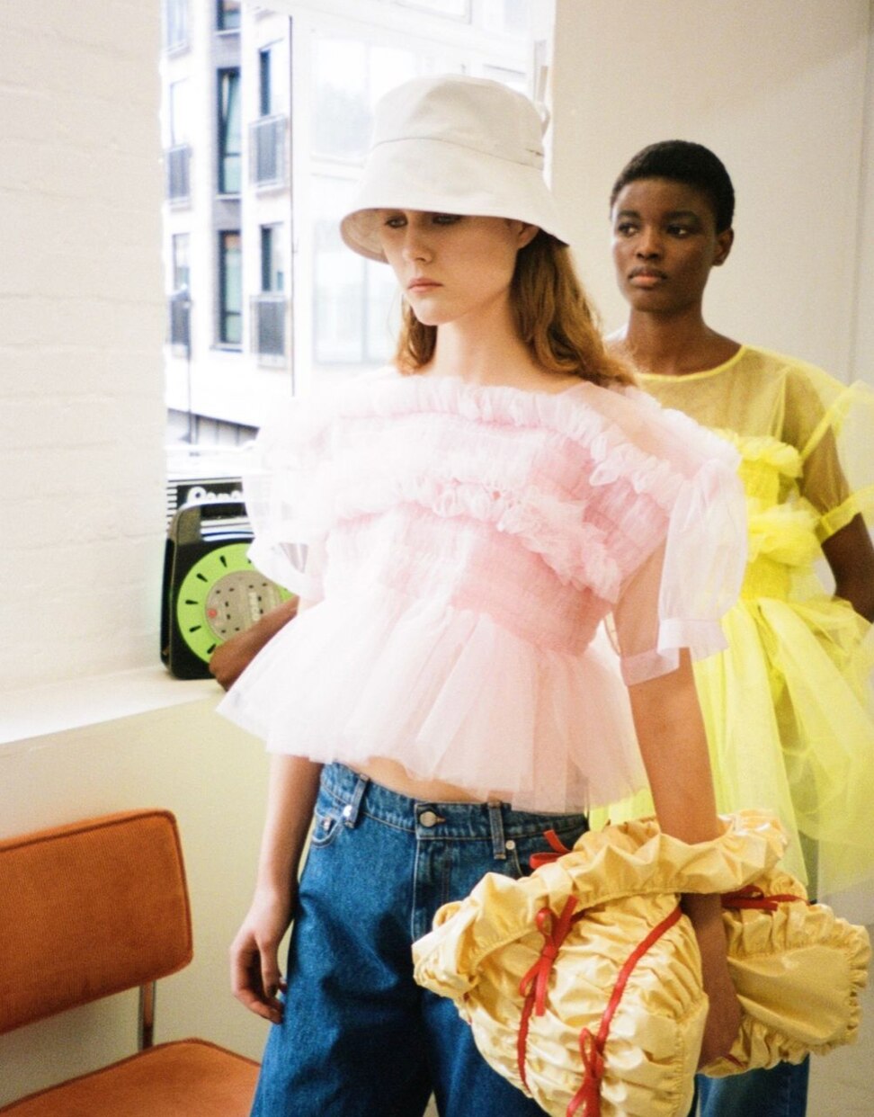 Photos of women wearing a sheer top over separates