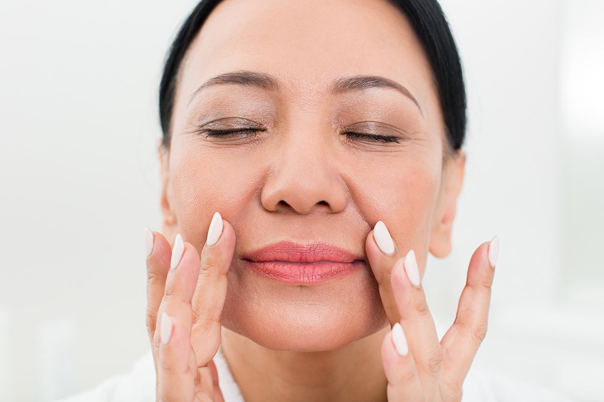 Asian woman putting product in retinol