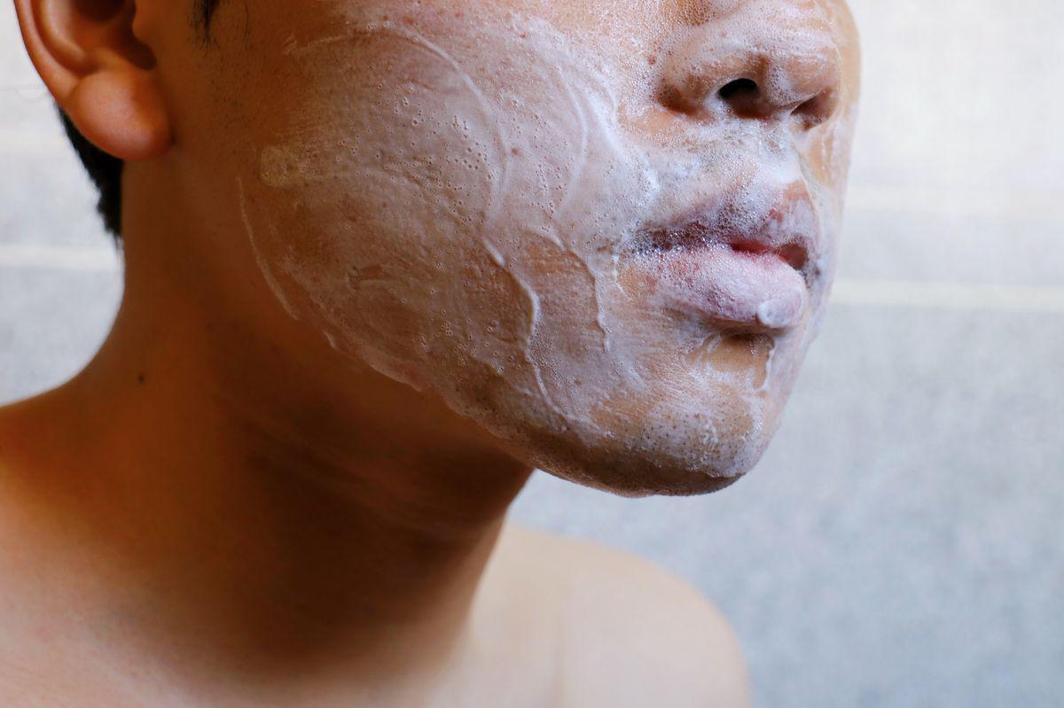 Asian man washing face 