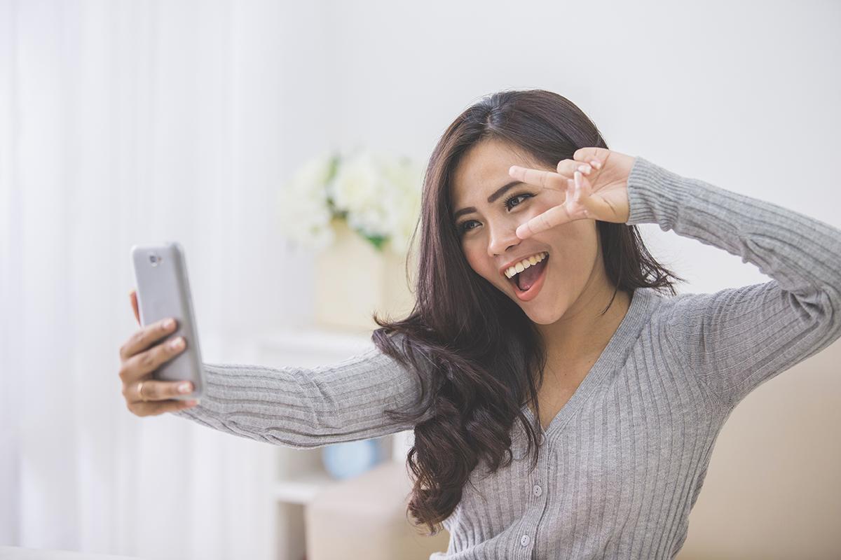 Asian woman taking a selfie