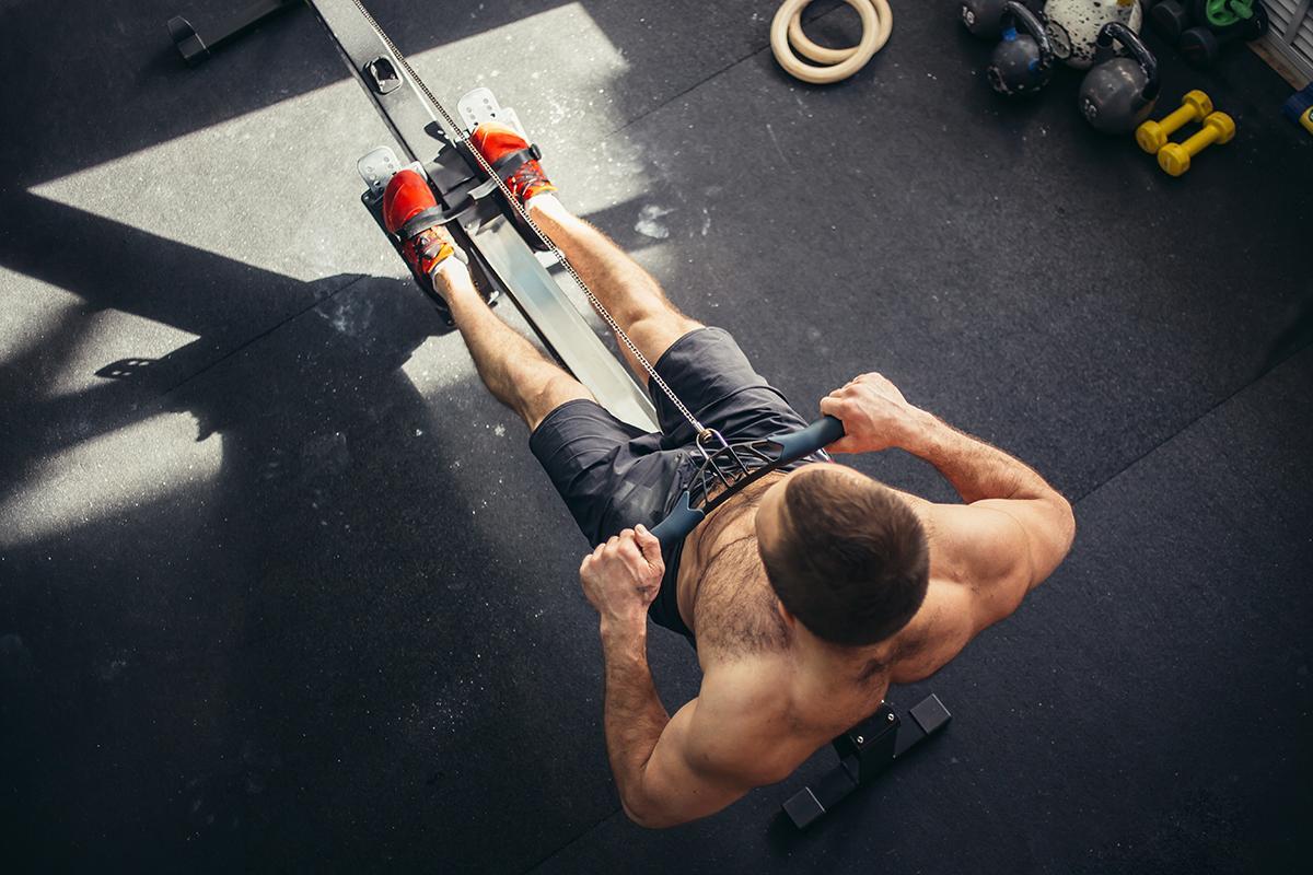 A man works out using a rowing machine