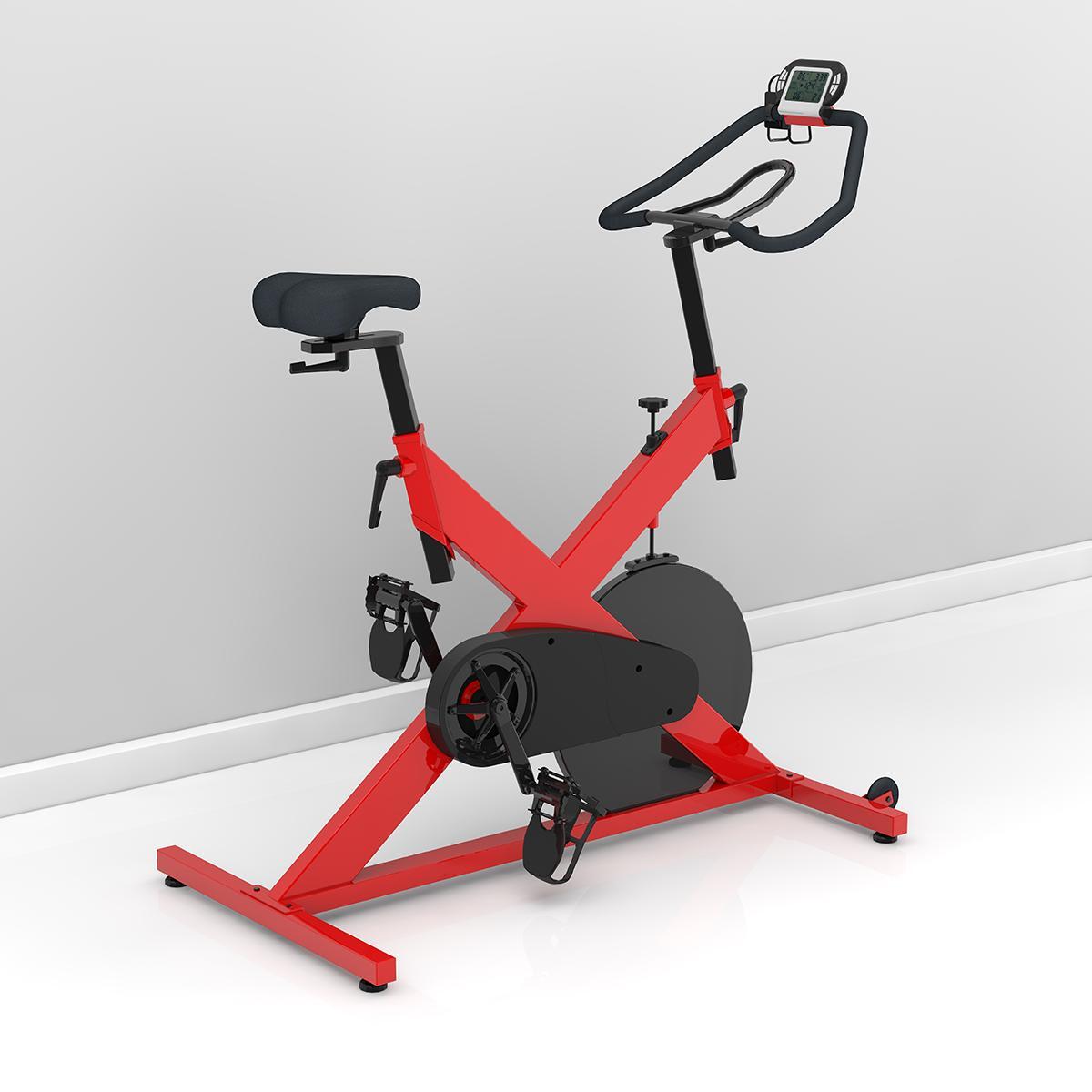 A red spinning machine stands beside a grey wall