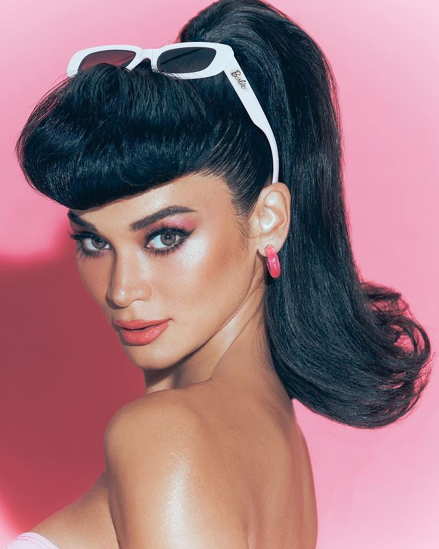 Pia Wurtzbach in pink Barbie inspired makeup look wearing white sunglasses on top of her head.