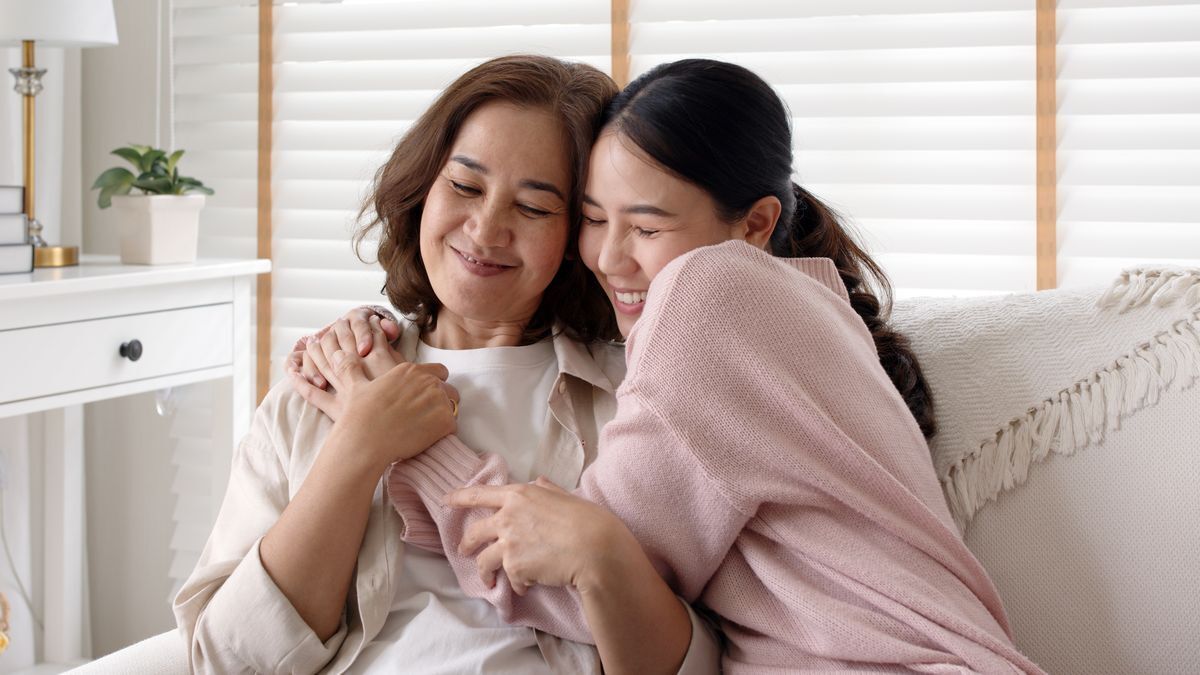 Asian mother and daughter hugging