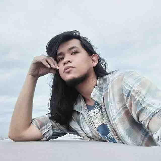 Portrait of a young man with long hair.