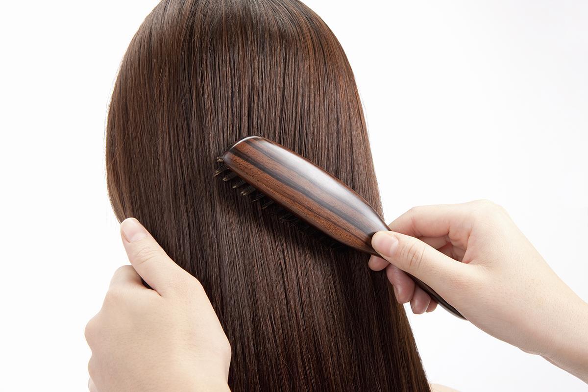 Woman brushing brown hair