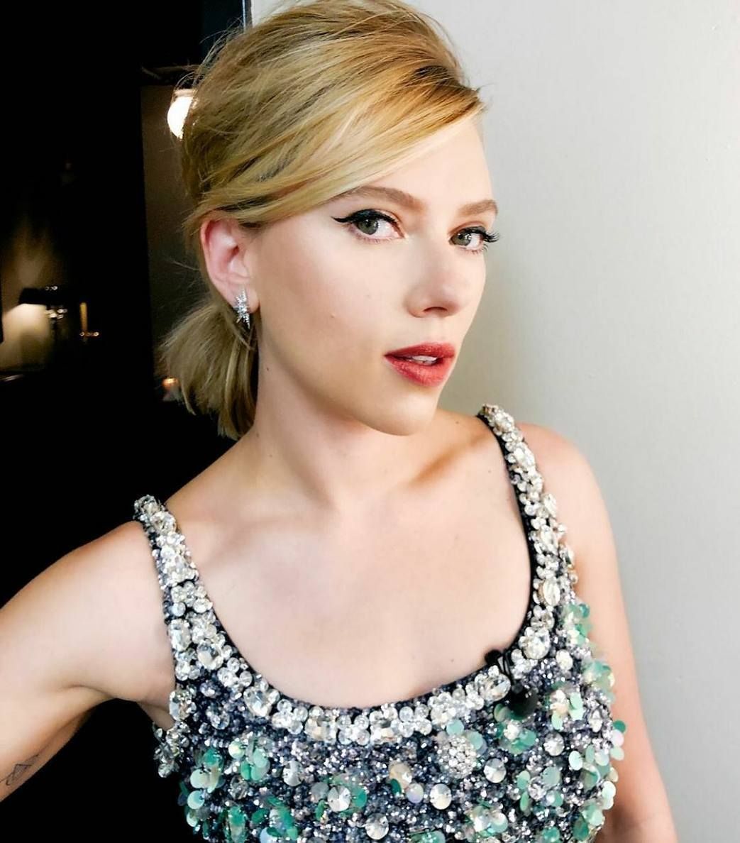 A portrait of Scarlett Johansson with bouffant ponytail.