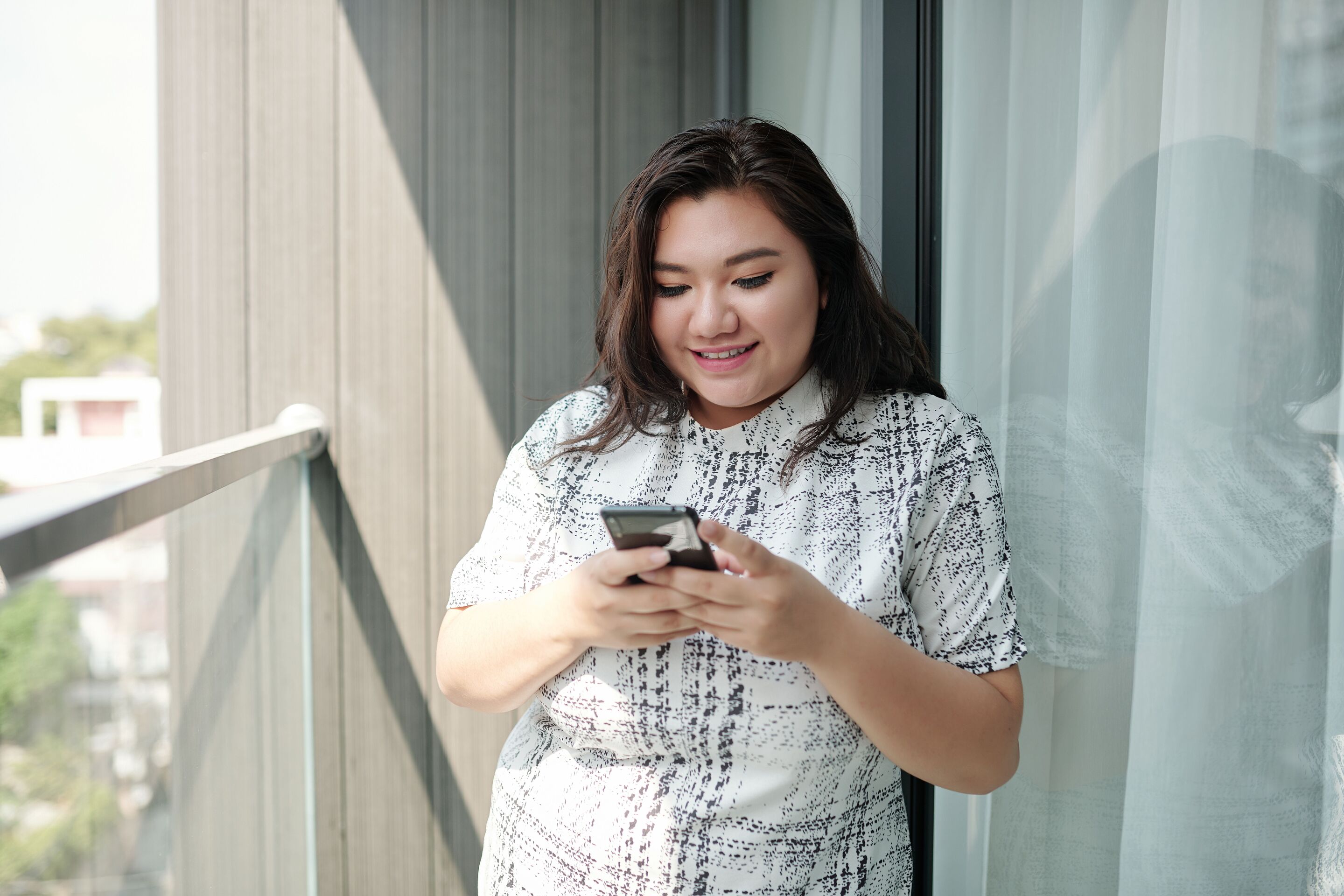 Curvy woman checking her phone.