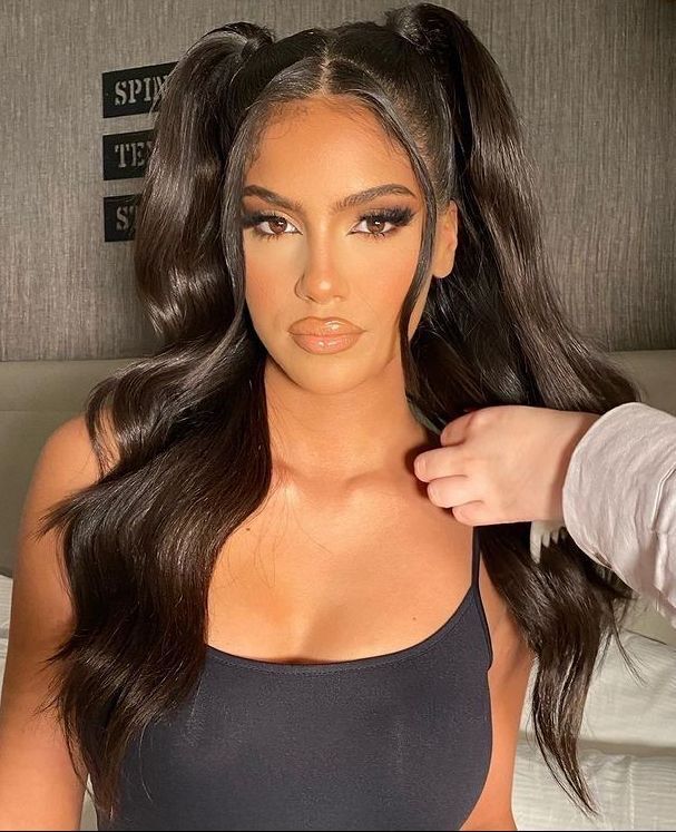 A portrait of woman with high pigtails.