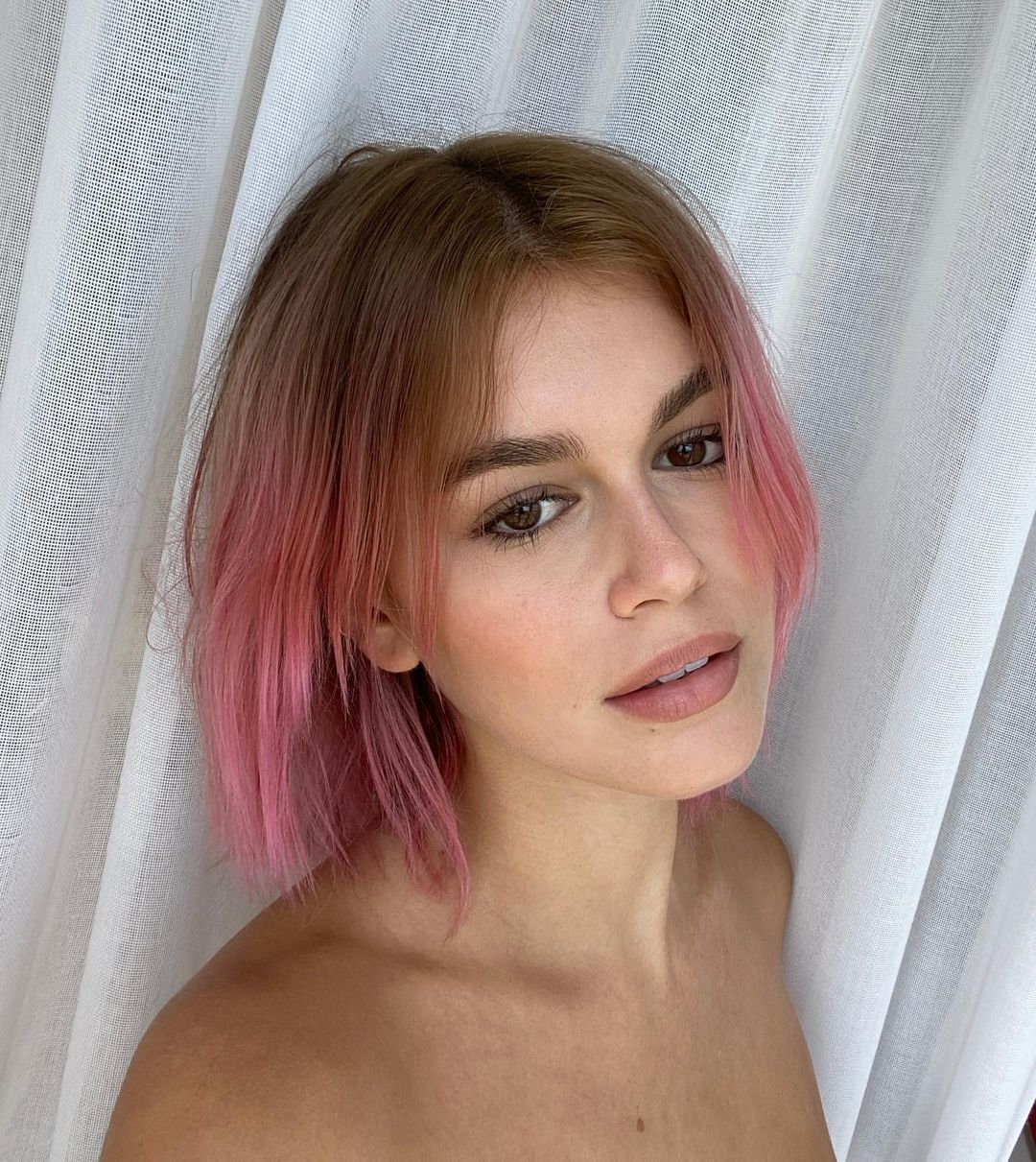 American model Kaia Gerber posing with her short pink hair