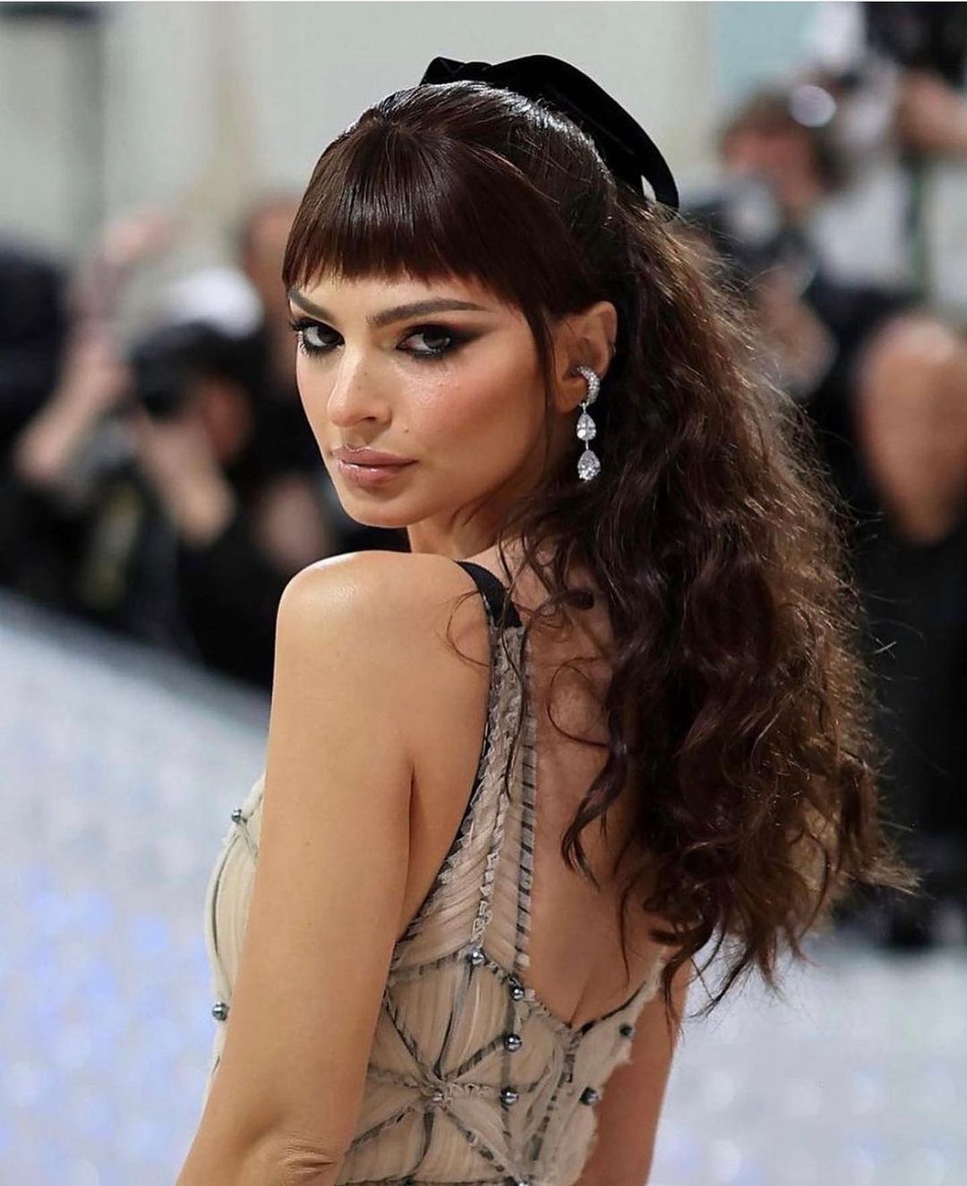 A portrait of Emily Ratajkowski with fake bangs at the Met Gala.
