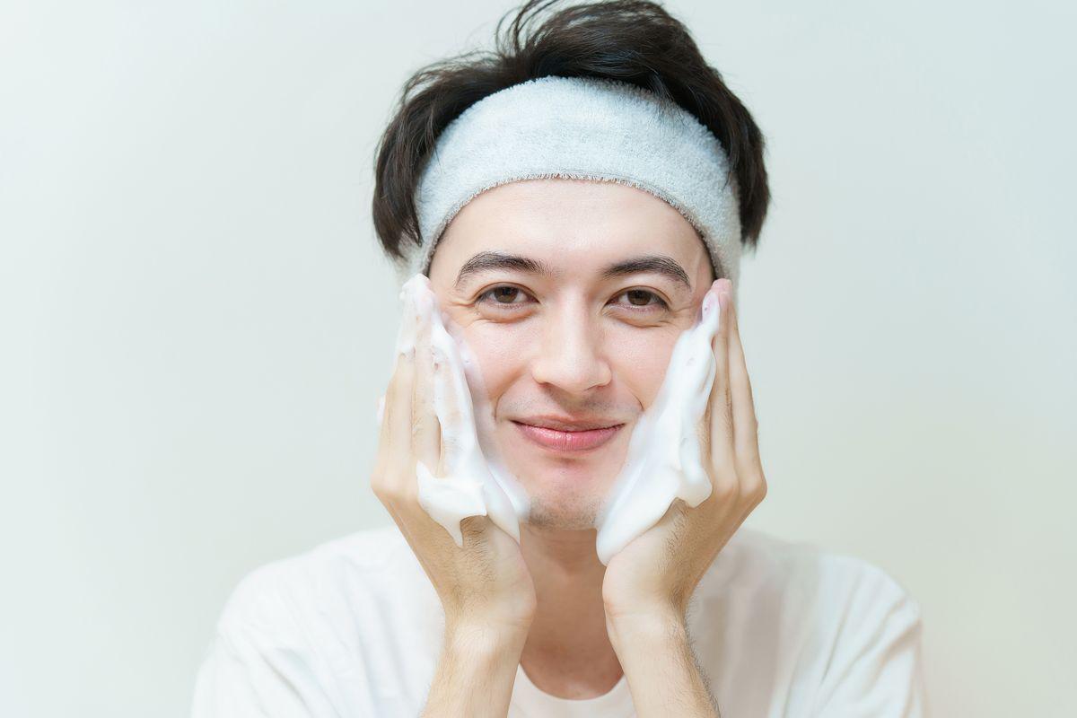 Asian man washing cheeks 