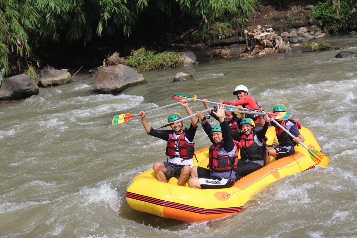 Group of Asian friends happily white water rafting.