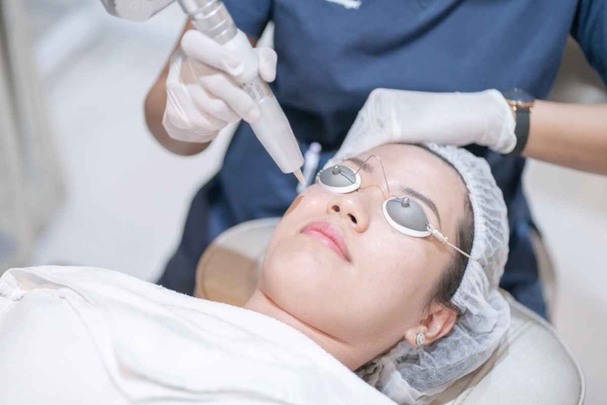 Woman getting a laser treatment for acne scars at a clinic.