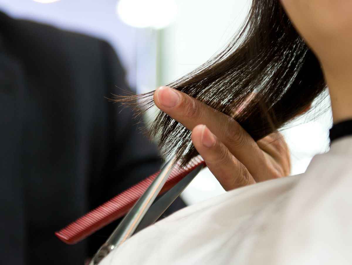 Asian woman getting a trim at the hair salon