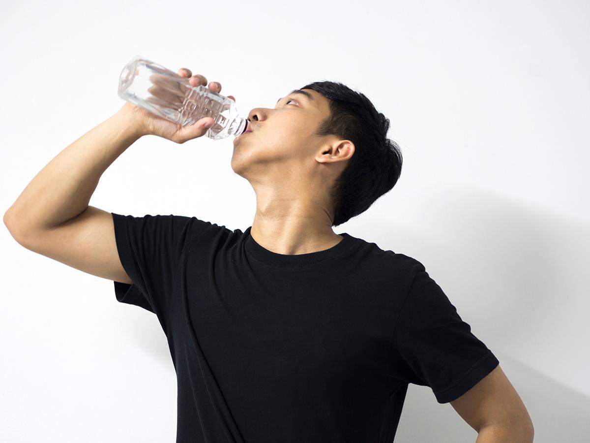 Asian man drinking water
