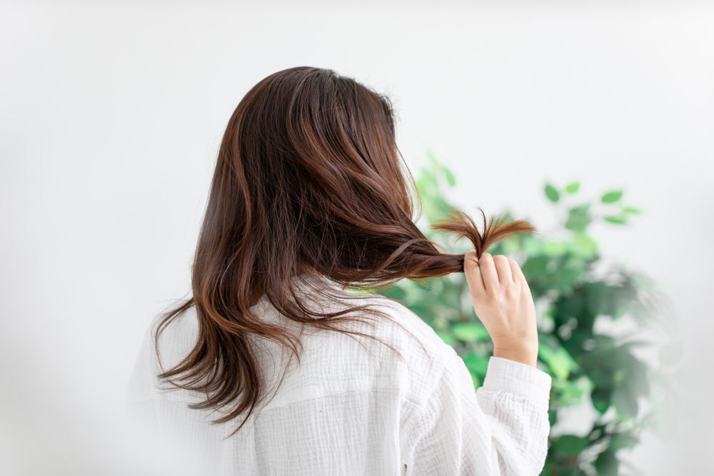 A woman touching her hair