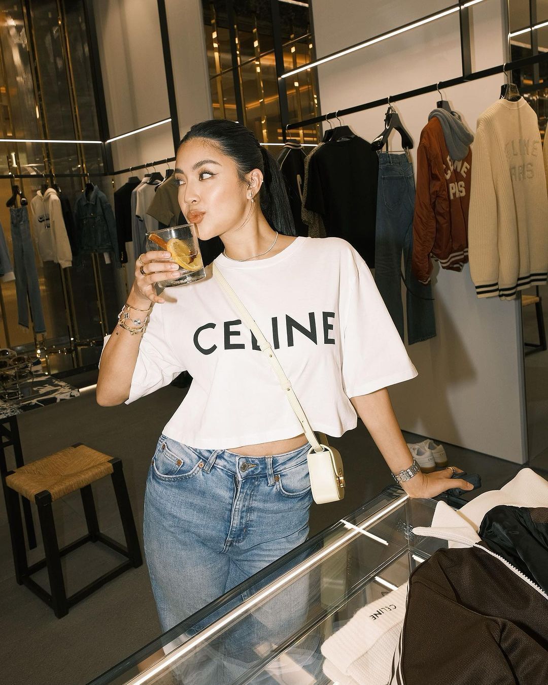 A portrait of Rei Germar wearing a Celine oversized shirt and jeans.