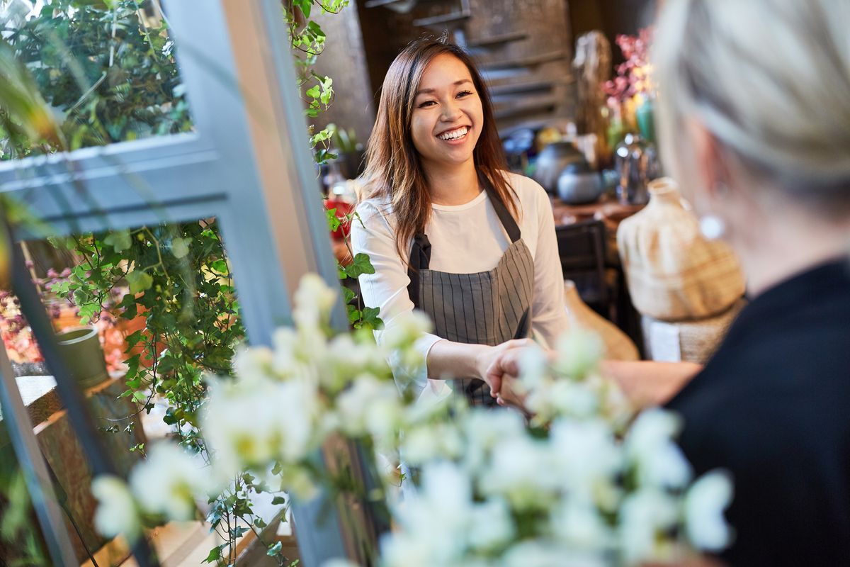 Asian business woman shaking a customer’s hand
