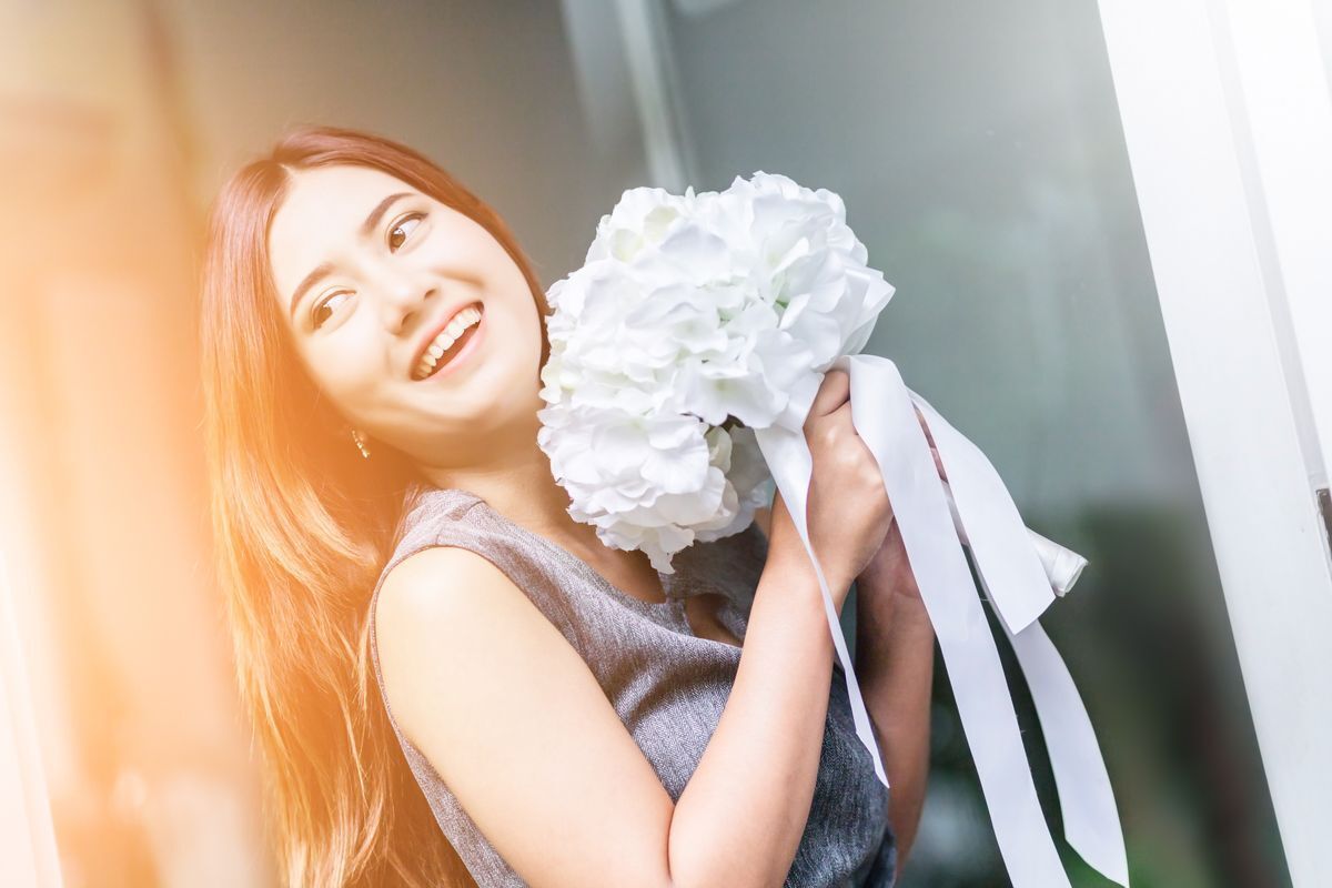 Asian woman holding flowers
