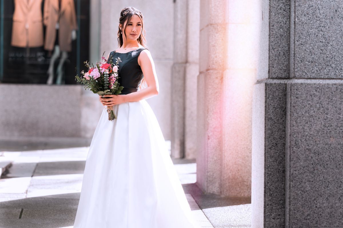 Asian woman in a black and white dress