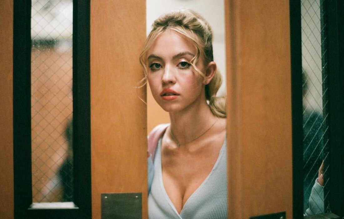 Blonde woman opening a door  