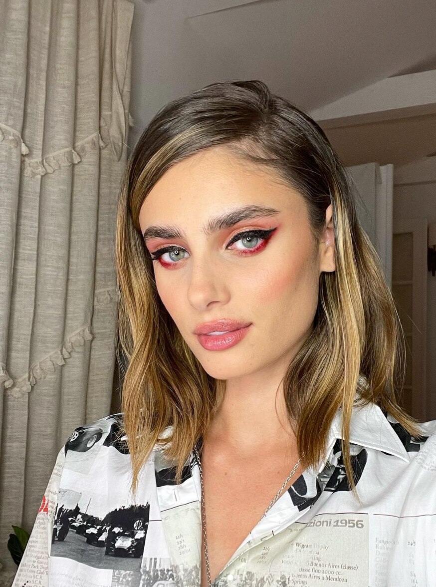 Caucasian woman with brown hair and eye makeup 
