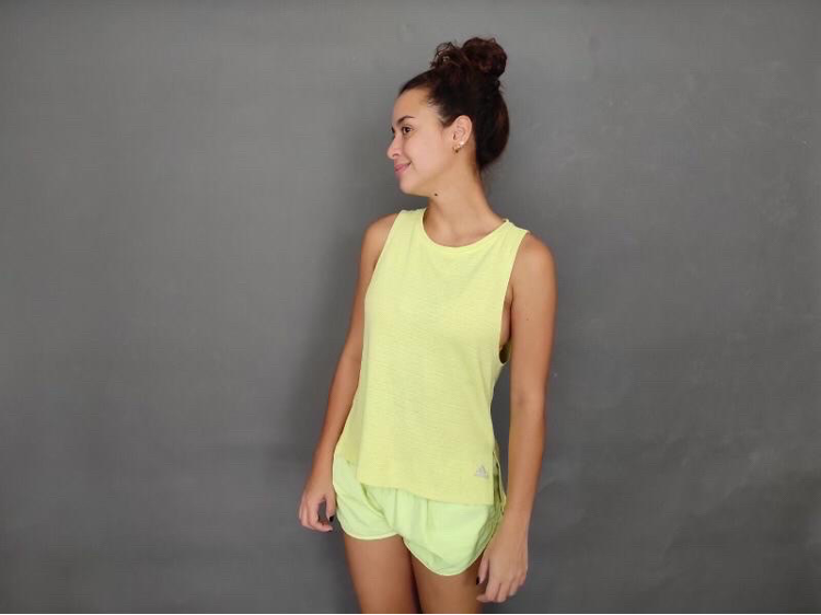 Yassi Pressman in a yellow top and shorts