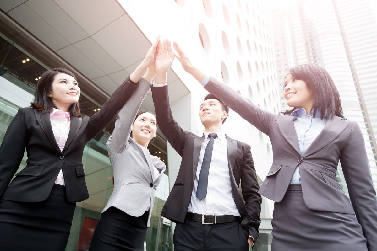 A team of Asian women and an Asian man 