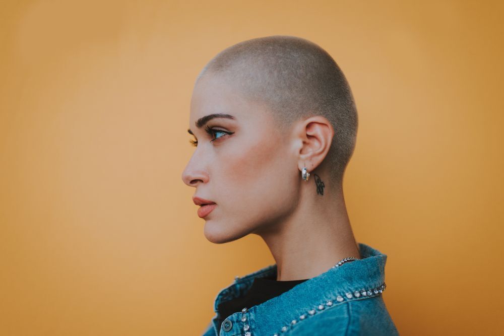 a beautiful woman with a buzz cut 