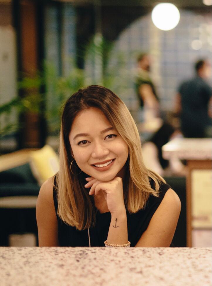A woman with blonde hair and a black top